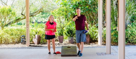 Couple plays cornhole at the best hotel on Sanibel Island