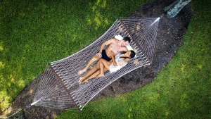 A couple relaxing on a hammock