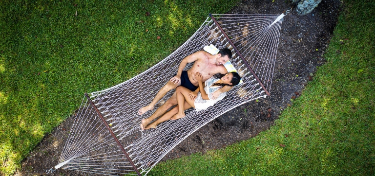 A couple relaxing on a hammock