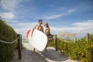 A couple go surfing at Sunset Beach