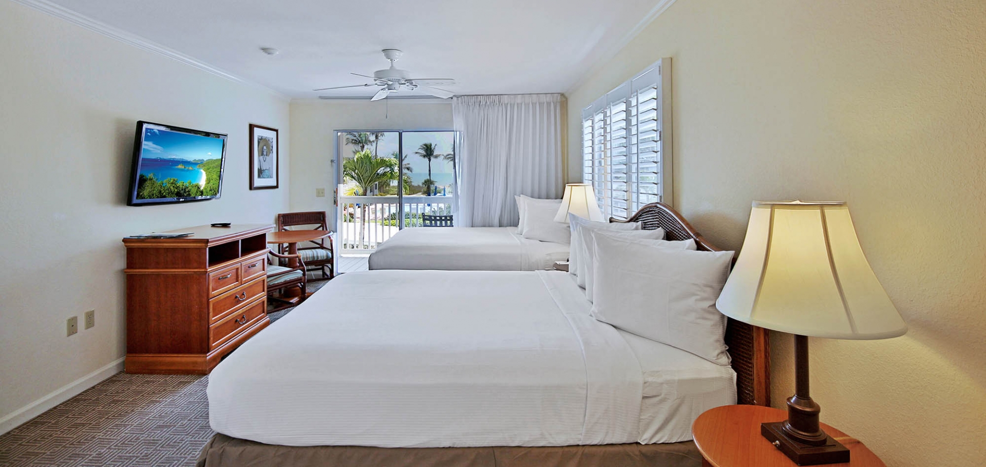 Sanibel's Seaside Inn guest room with two beds and balcony view